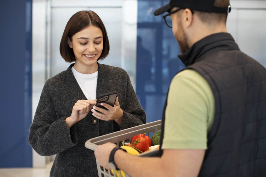 woman-in-the-netherlands-paying-for-grocery-delivery-with-mobile-banking-app