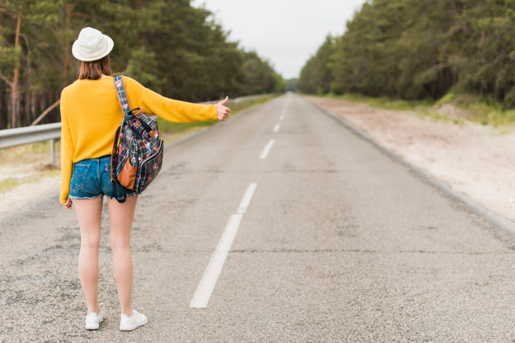 woman-in-yellow-jumper-and-shorts-hitchhiking-through-the-netherlands