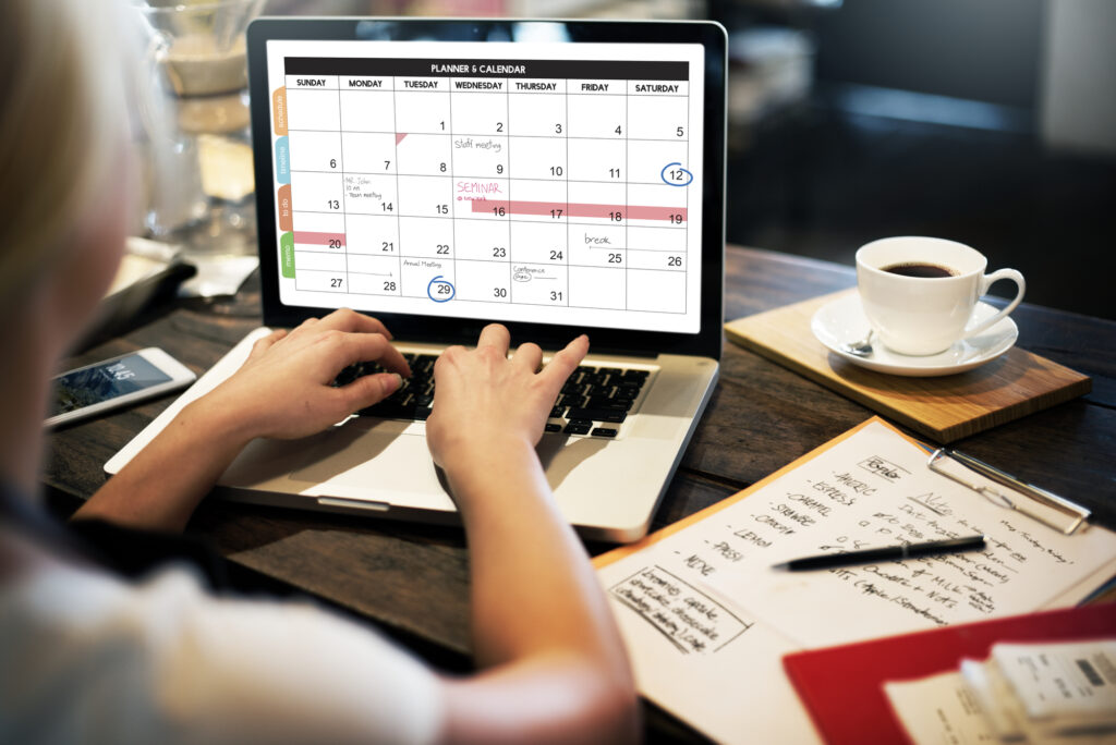 woman-writing-on-laptop-online-calendar