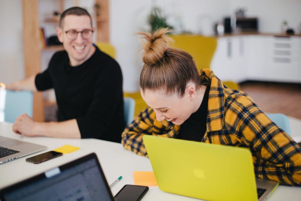 photo-of-woman-at-dutch-workplace-laughing-at-colleagues-joke