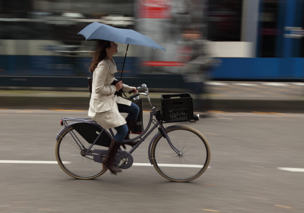 woman-cycling-with-umbrella