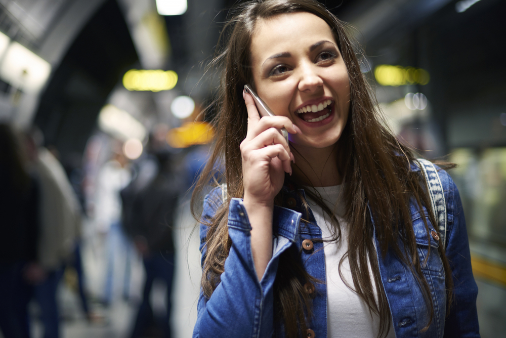 a-picture-of-woman-on-cellphone-talking-denim-jacket-phone-on-against-ear-straight-brown-hair