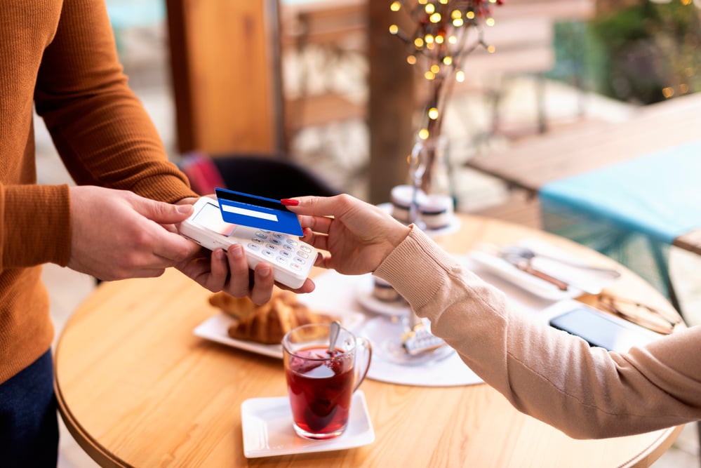 woman-pays-for-drink-and-snack-with-credit-card-after-setting-up-banking-in-the-netherlands