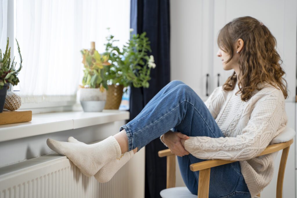 woman-sitting-near-heater-using-gas-in-the-netherlands