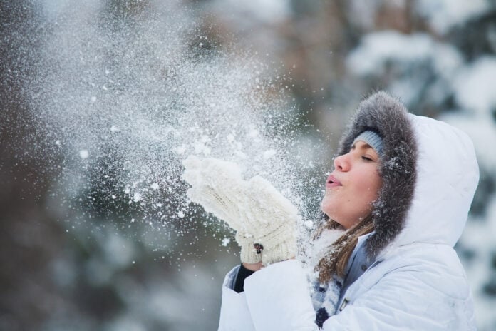 woman-blowing-snow-in-winter