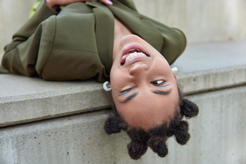 photo-of-woman-lying-on-bench-twisting-tongue-confused