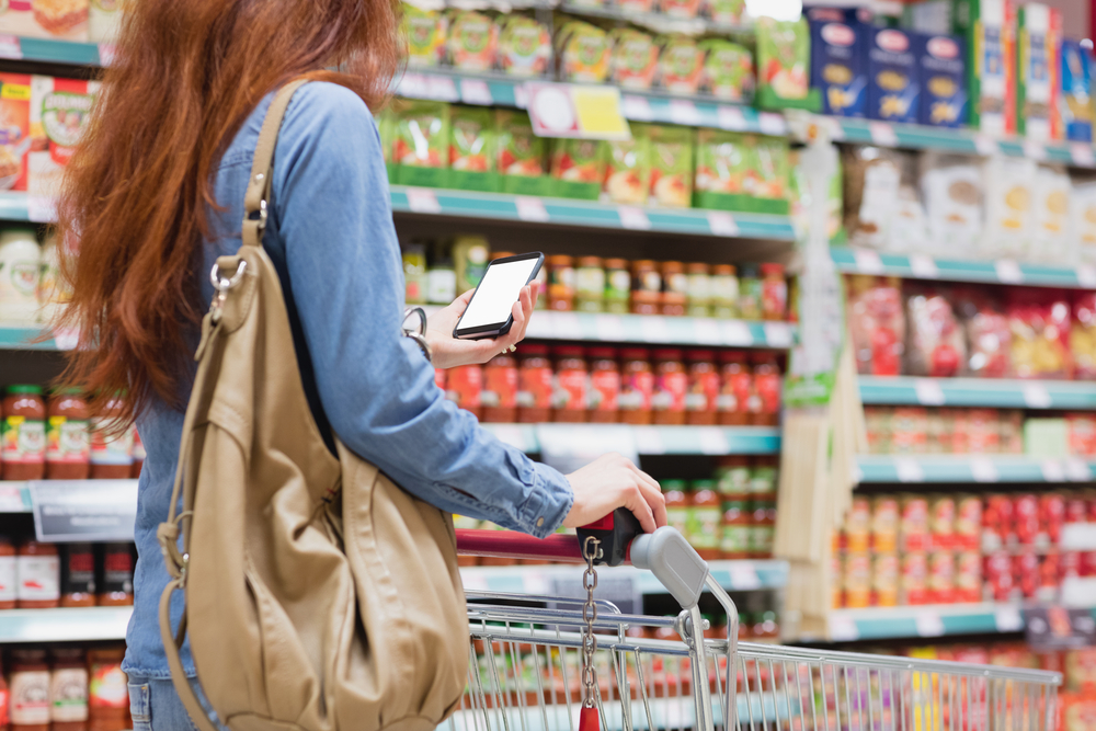 photo-of-woman-using-phone-while-shopping-in-checkout-free-store-aldi