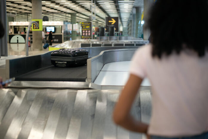 Photo-of-woman-waiting-at-baggage-belt-Schiphol