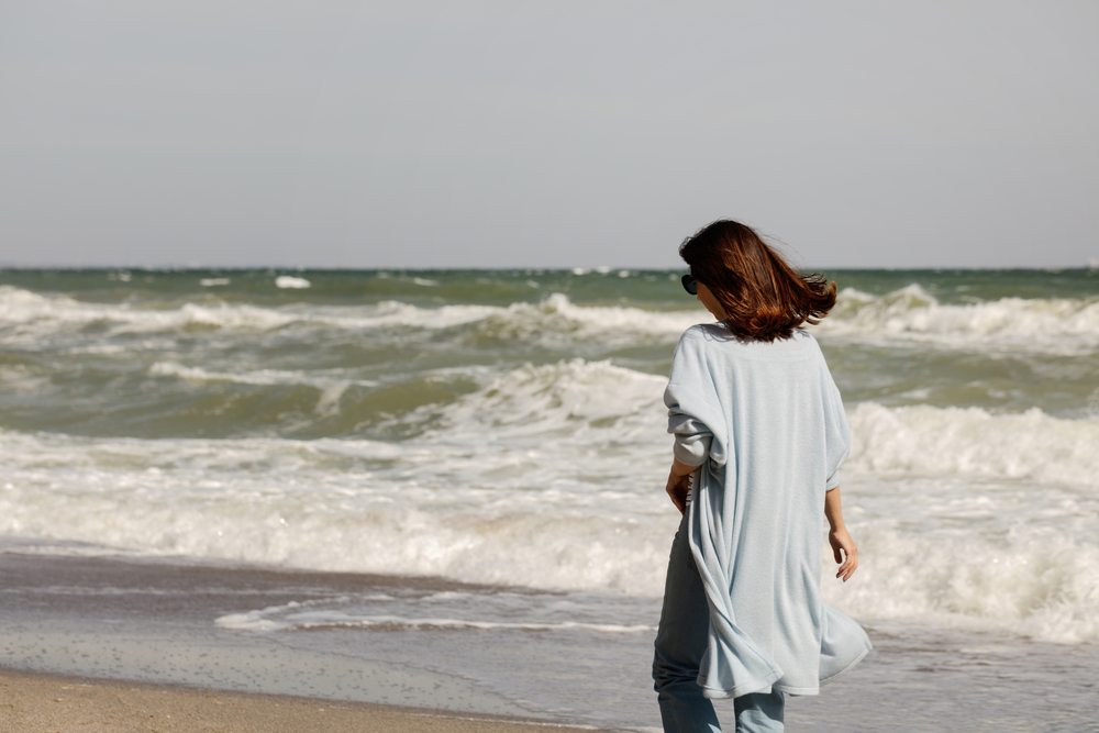 picture-of-woman-walking-on-a-windy-beach