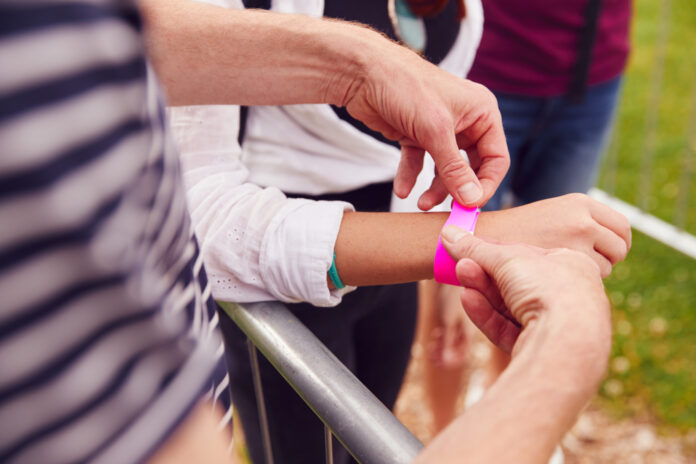 person-getting-pink-wristband