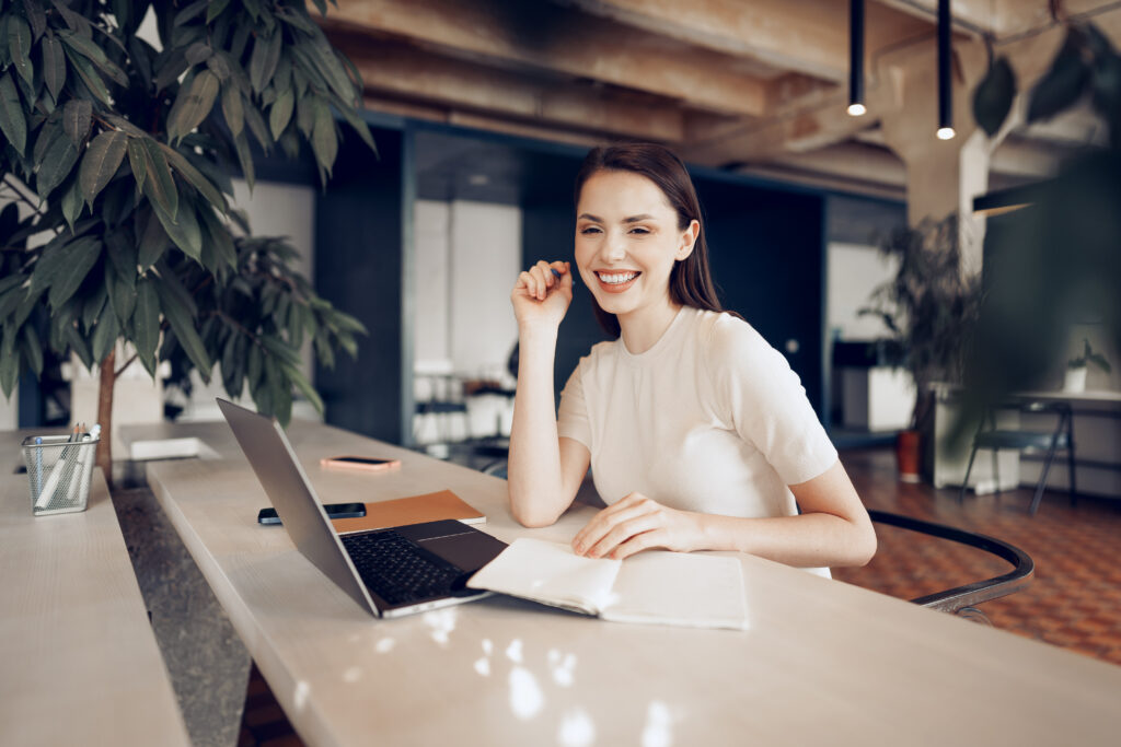 young-woman-applying-to-stap-in-the-Netherlands-with-her-laptop-and-notes-next-to-her