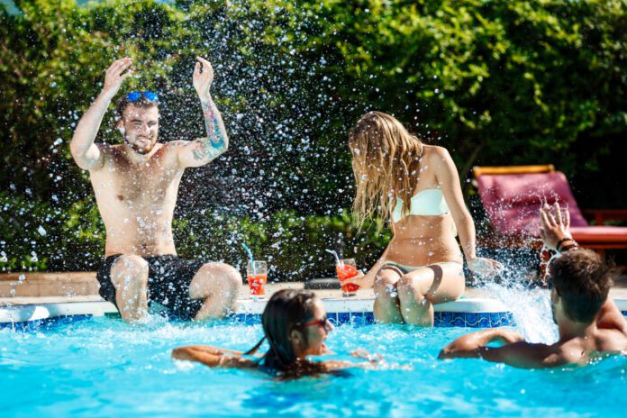photo-of-friends-splashing-in-pool-on-hot-summer-day-in-the-netherlands