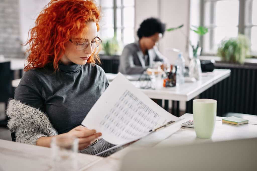 young-redheaded-freelancer-in-the-netherlands-runs-through-company-accounts-for-tax-purposes