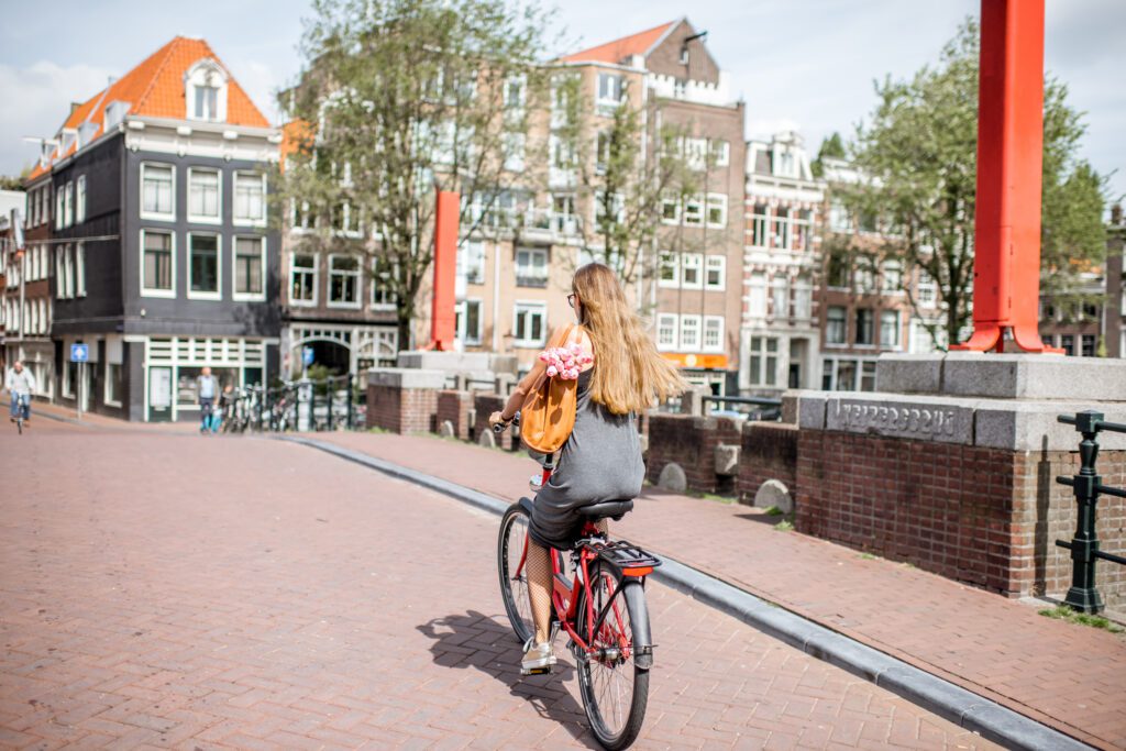 young-woman-biking-in-the-netherlands-flat-country-amsterdam