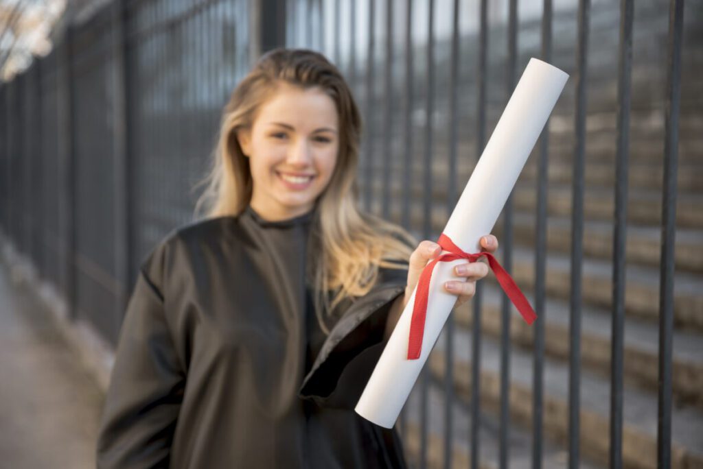 young-woman-smiling-holding-her-MBA-degree-ready-to-find-work-in-the-Netherlands