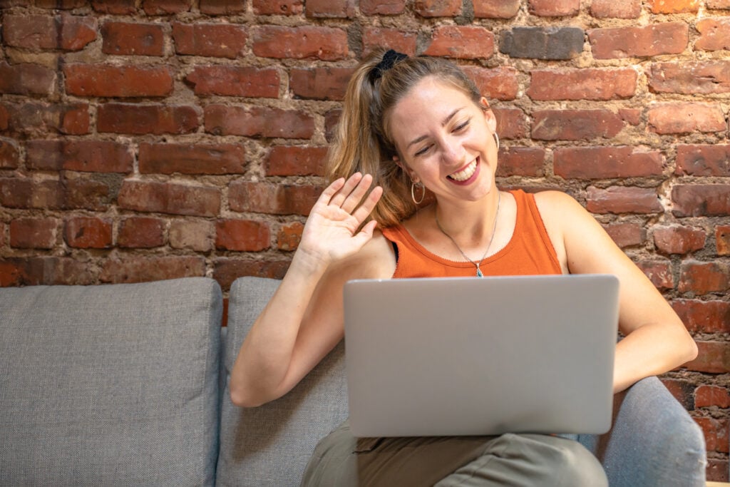 young-woman-talking-to-online-friends-on-her-laptop