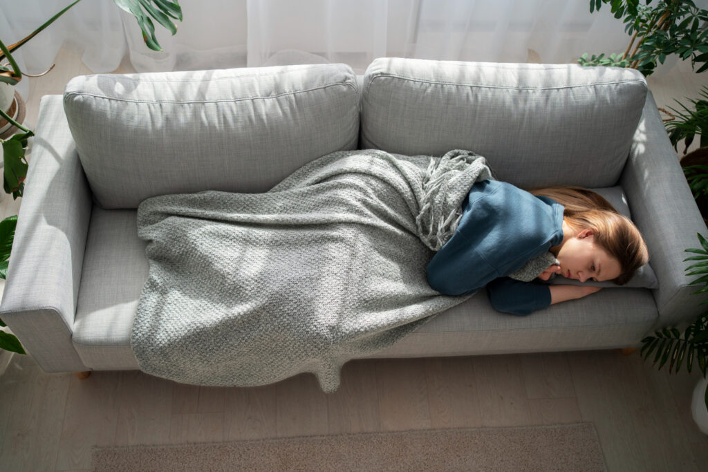 photo-of-woman-lying-on-couch-with-burnout-taking-sick-leave-from-work-in-the-Netherlands